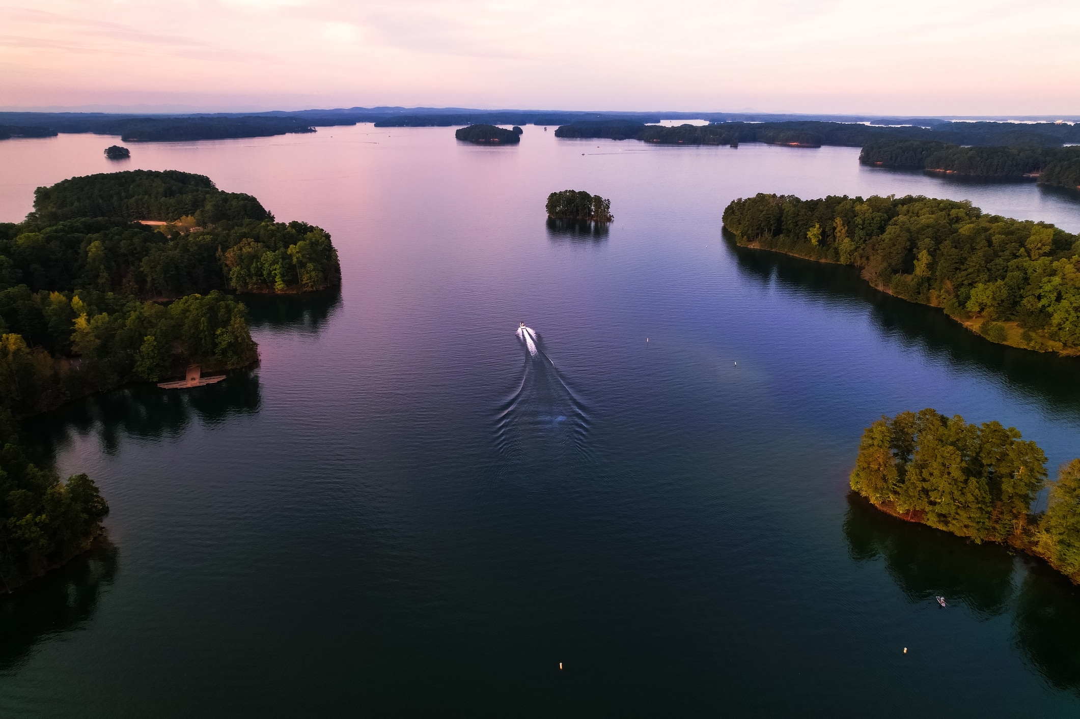 boat is out on Lake Lanier at sunset