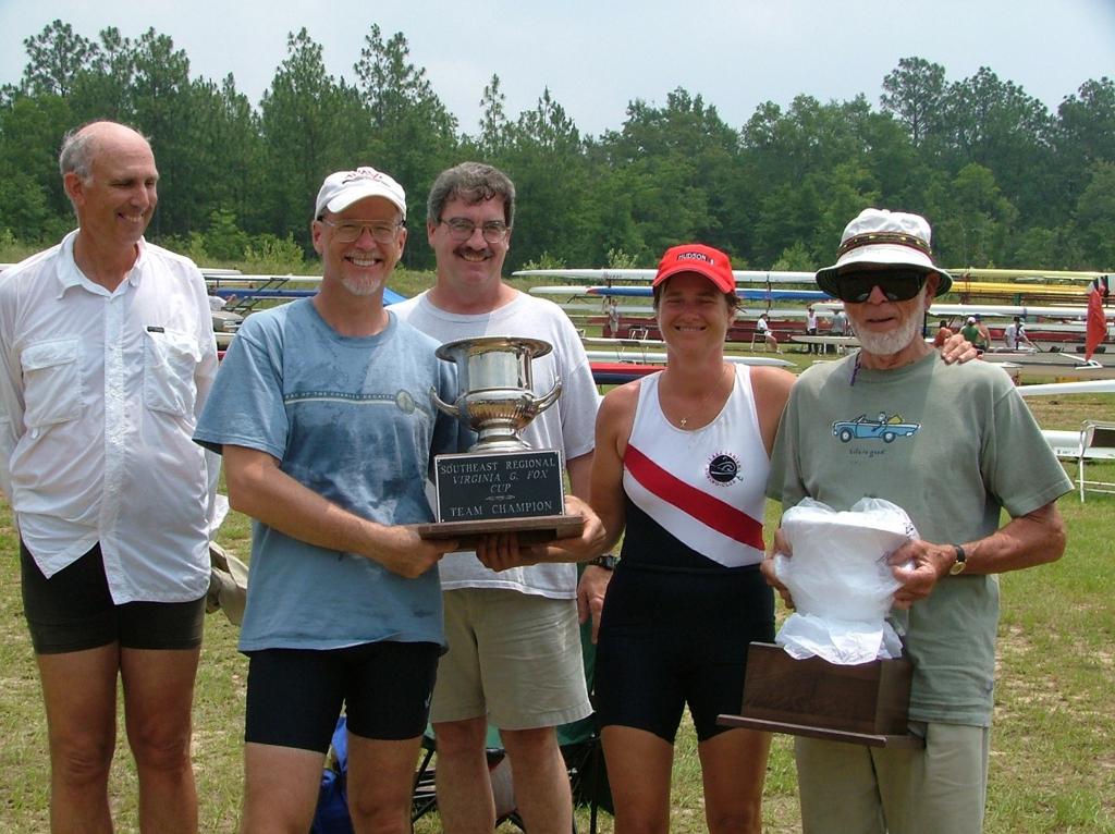 Ferriss and team member smiling for a picture with their trophy