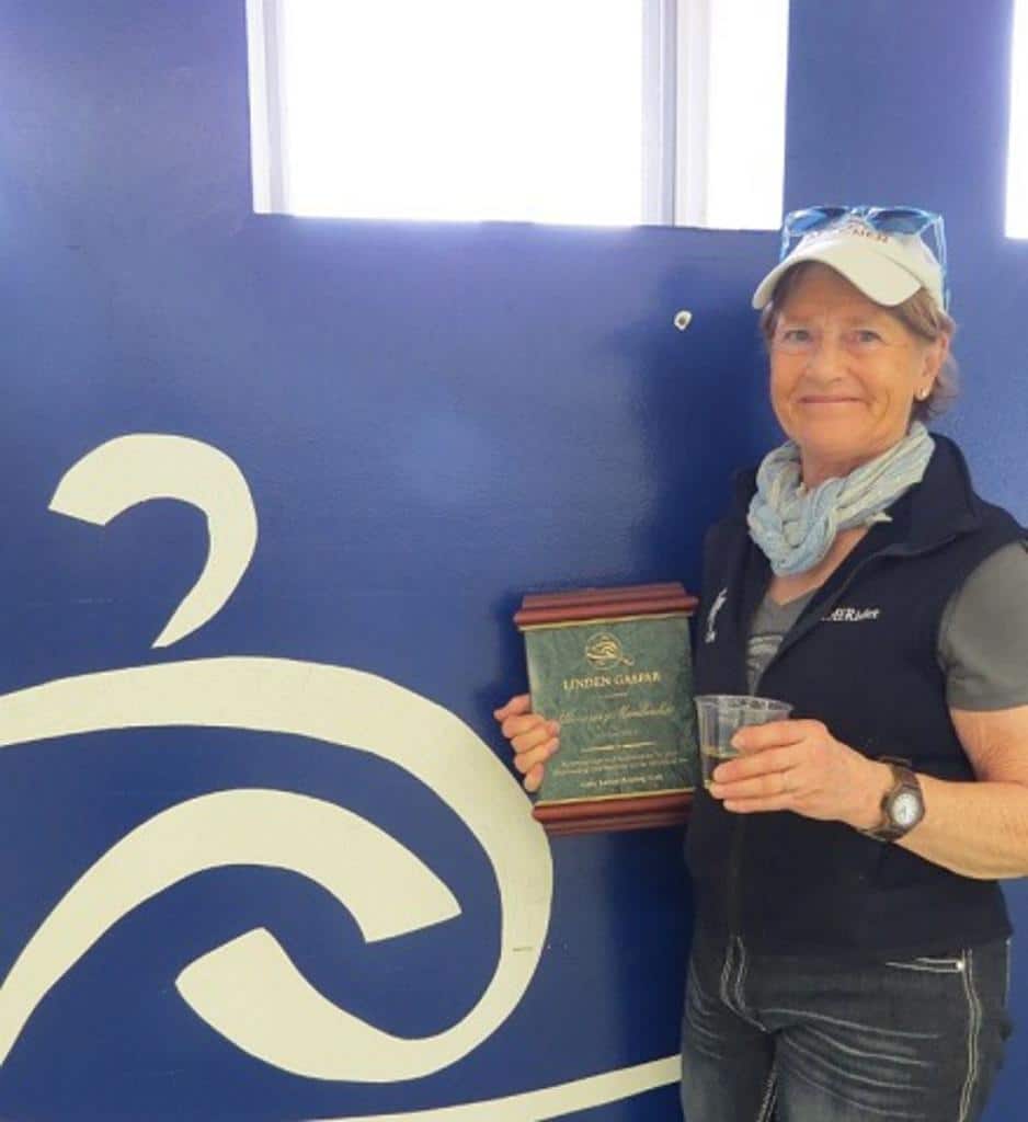 Mrs. Gaspar posing with an award