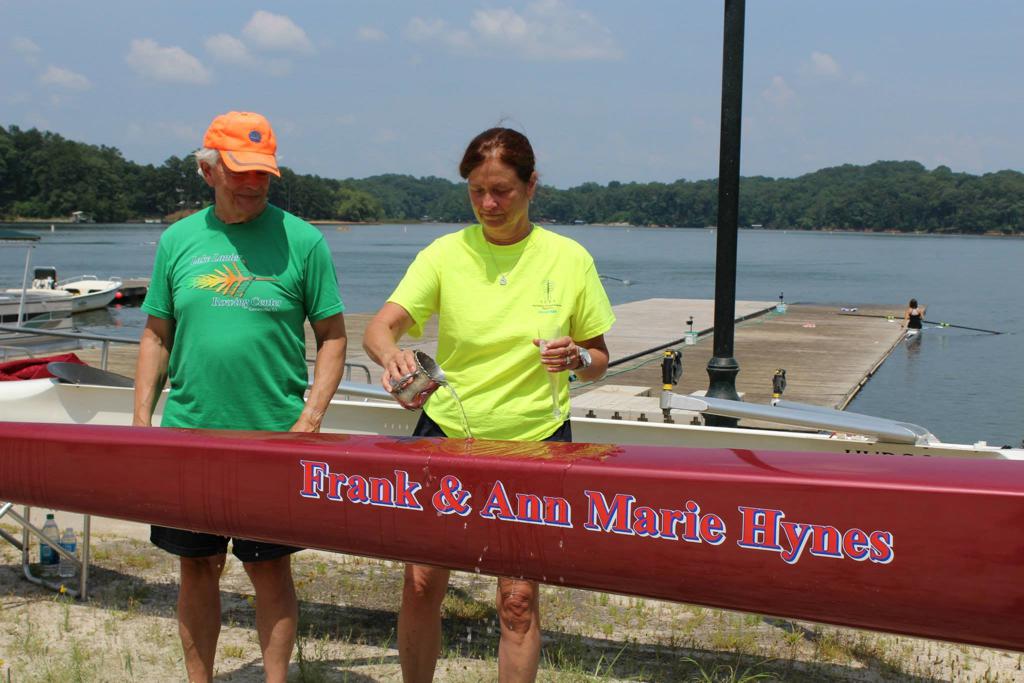 The Hynes pouring water onto their rowing boat