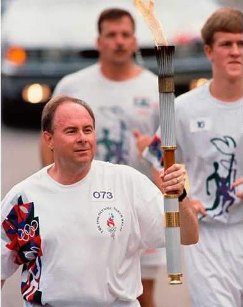 Mathis running with torch on parade