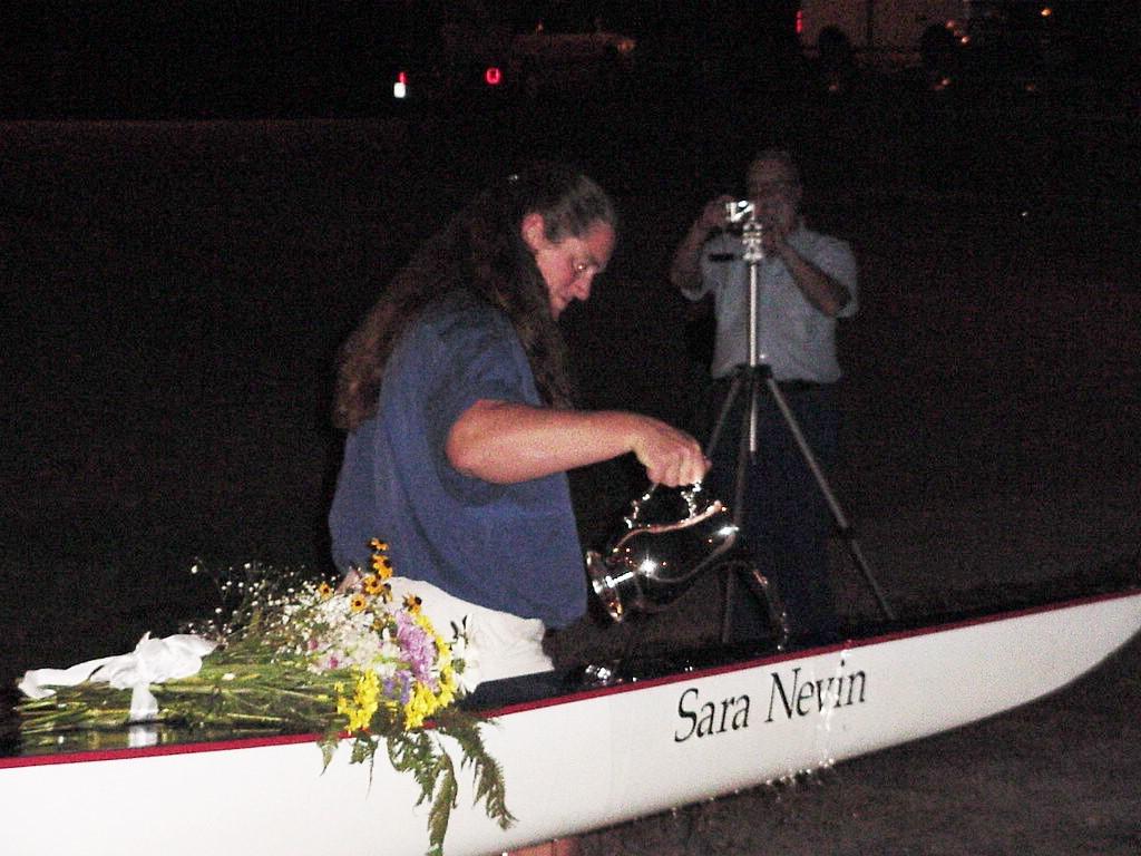 Nevin pouring water on her rowing boat
