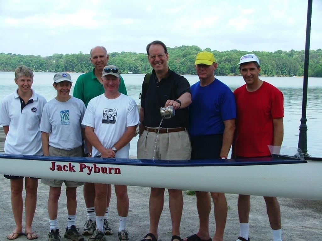 Pyburn pouring water on his rowing boat