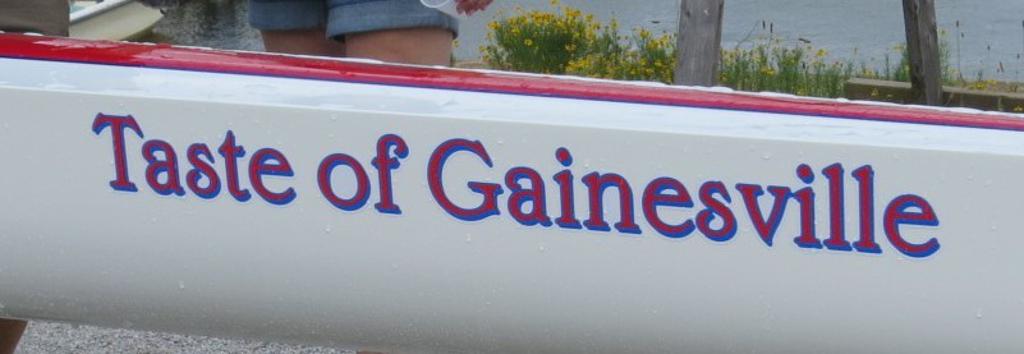 "Taste of Gainesville" printed on the side of a boat