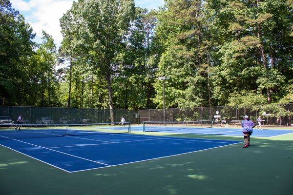 Ladies playing tennis at Longwood Park
