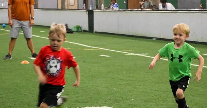 Young boys and coach playing at OSO Sports